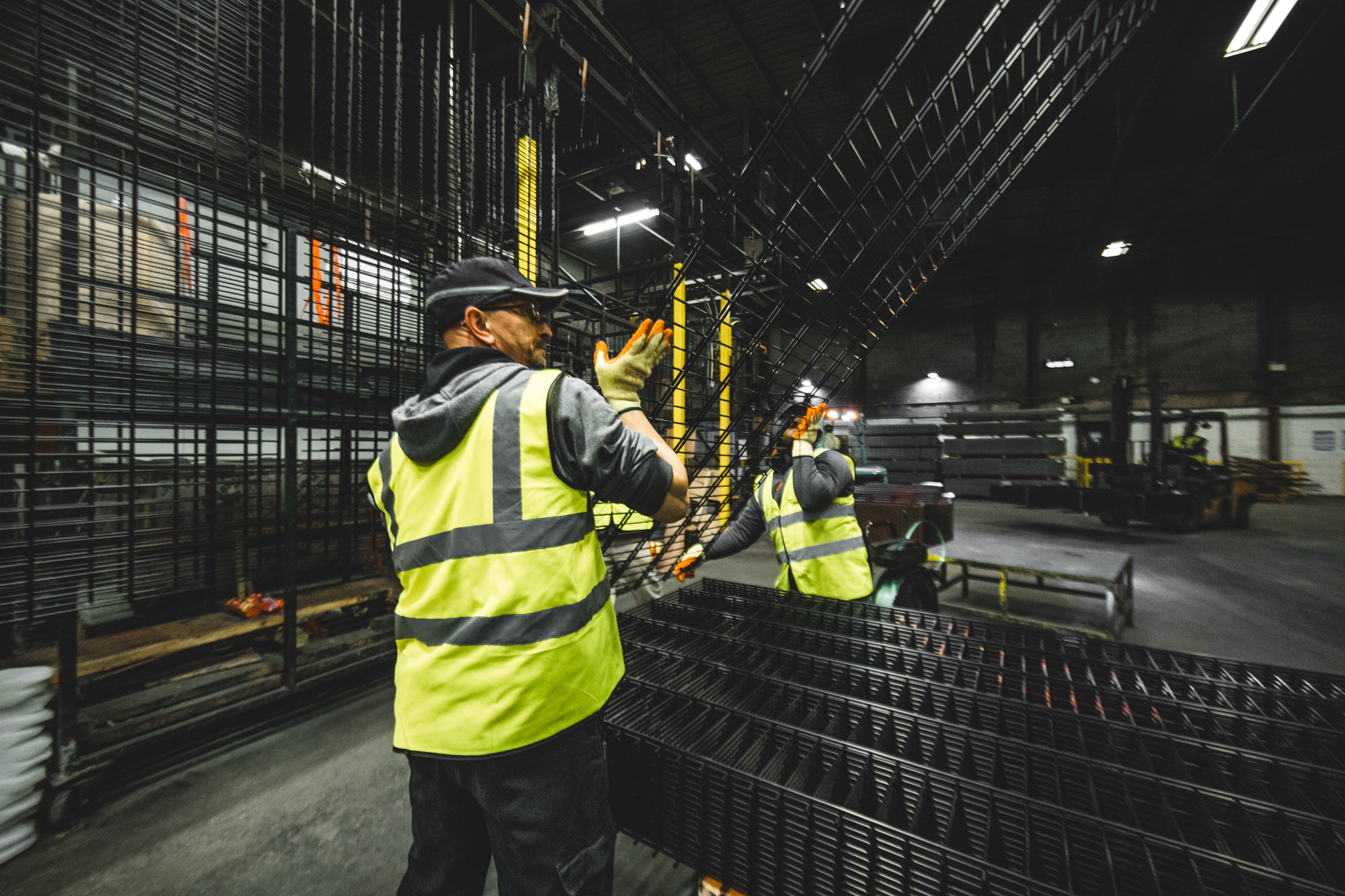 mesh fence panels being prepared for wrapping following powder coating