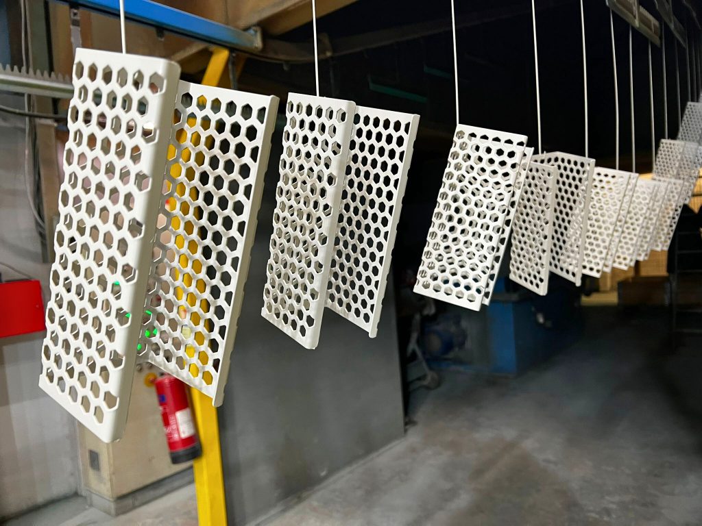 Perforated sheet metal panels on the powder coating line